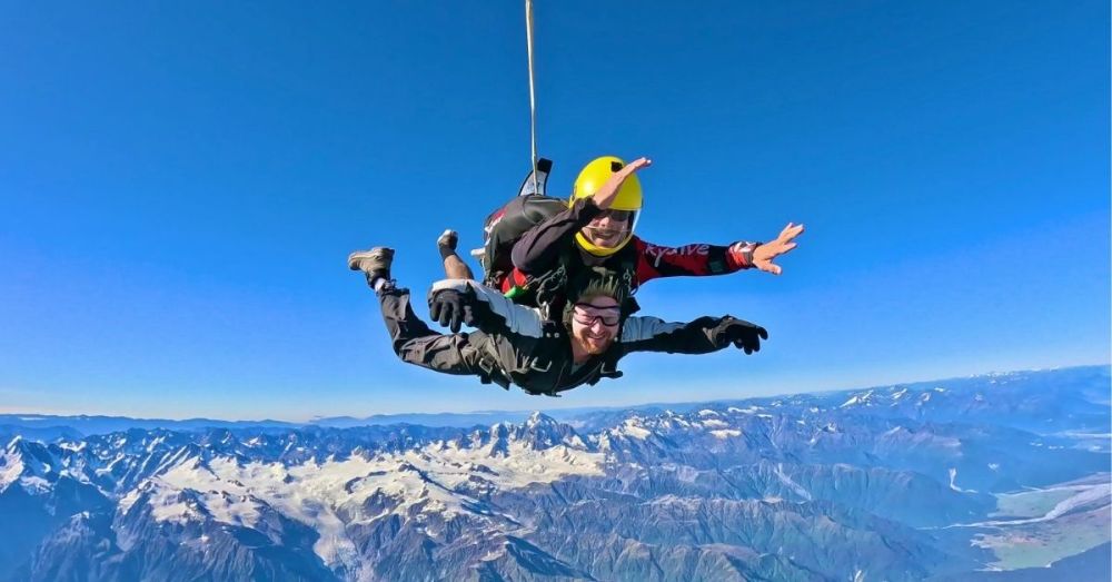 a man flying through the air on a snow covered mountain