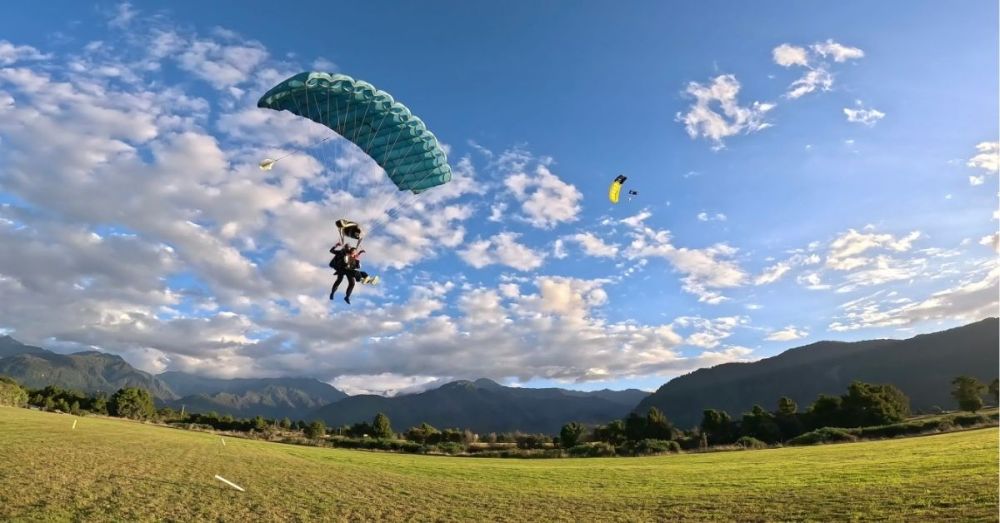 a group of people flying kites in a field