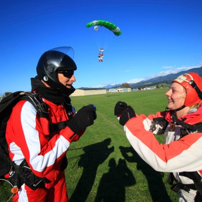 a group of people that are standing in the grass