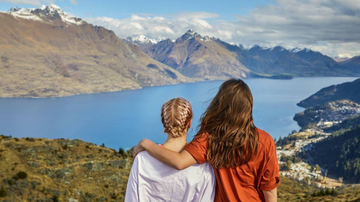 a person standing in front of a mountain