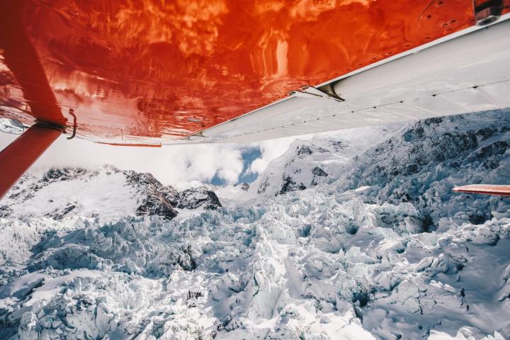 a person riding a snowboard down a snow covered slope