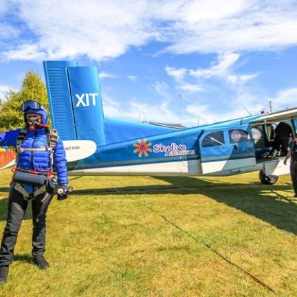 a group of people standing around a plane