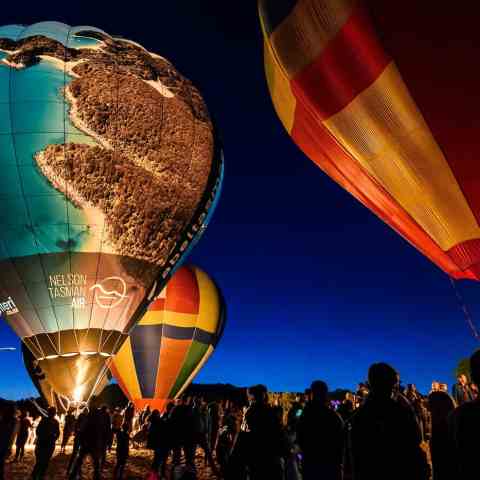 a group of people balloon in the sky