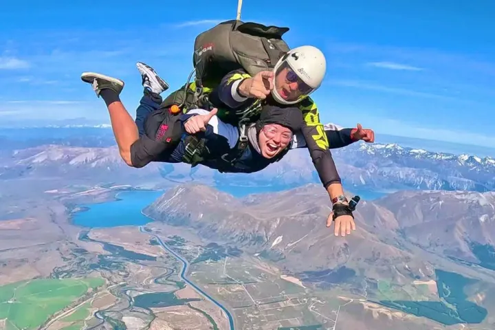 a man flying through the air on top of a mountain