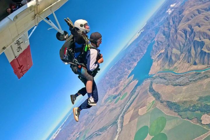a man flying through the air while riding a skateboard on a ramp
