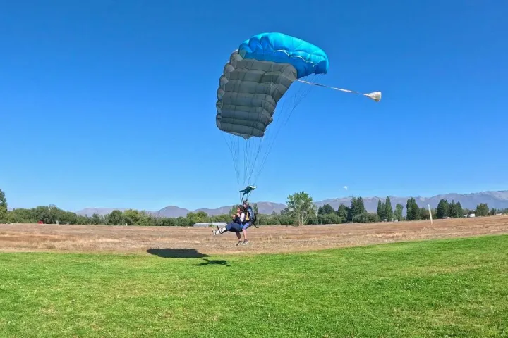 a person flying a kite in a field