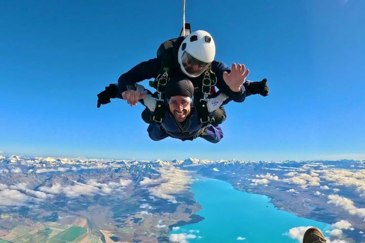a man flying through the air on a snow covered mountain