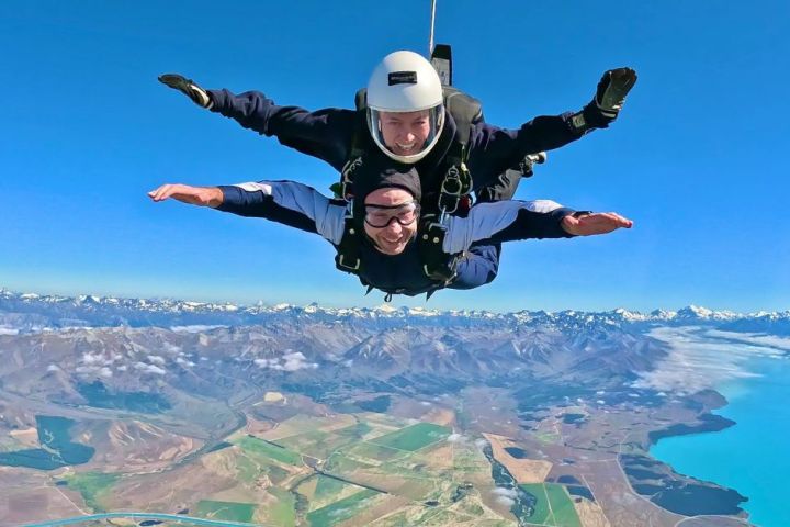 a person flying through the air on top of a mountain