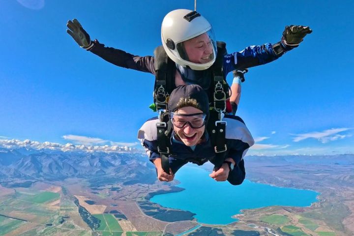 a person flying through the air on top of a mountain