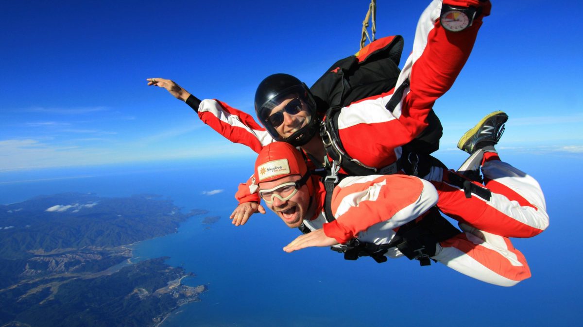 Skydive-Abel-Tasman-by-INFLITE-47-1 a man flying through the air while riding a motorcycle