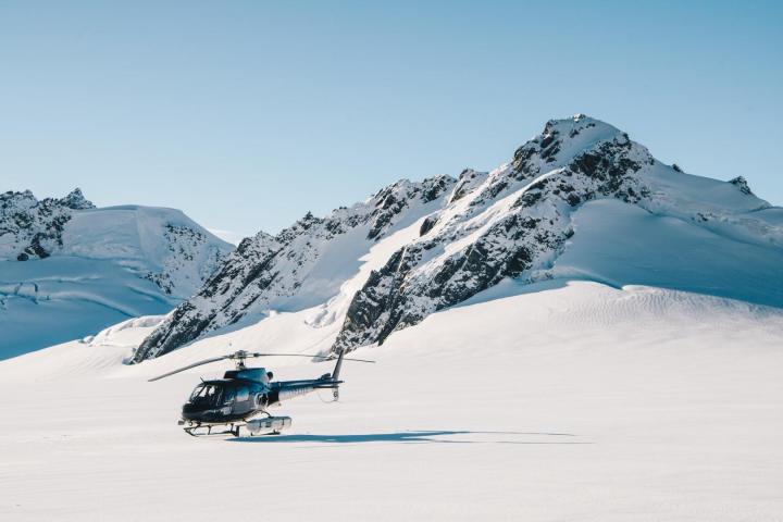 a man riding skis down a snow covered mountain