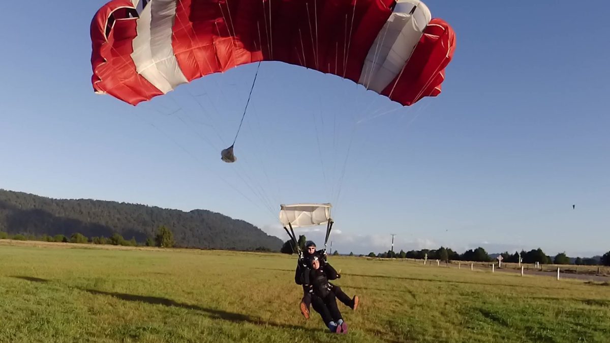 a man flying a kite in a field