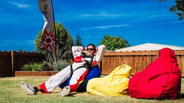 Skydive-Abel-Tasman-by-INFLITE-32 a person lying on a colorful blanket