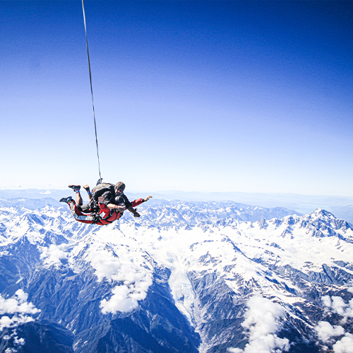 a group of people riding skis on top of a snow covered mountain