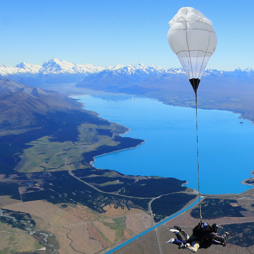 a person flying through the air on top of a mountain