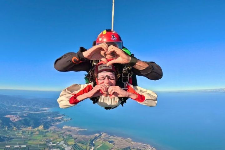 a person flying through the air over a body of water