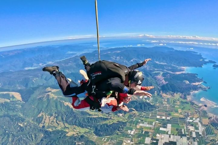 a man flying through the air on top of a mountain