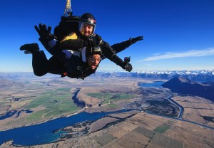 a man flying through the air on top of a mountain