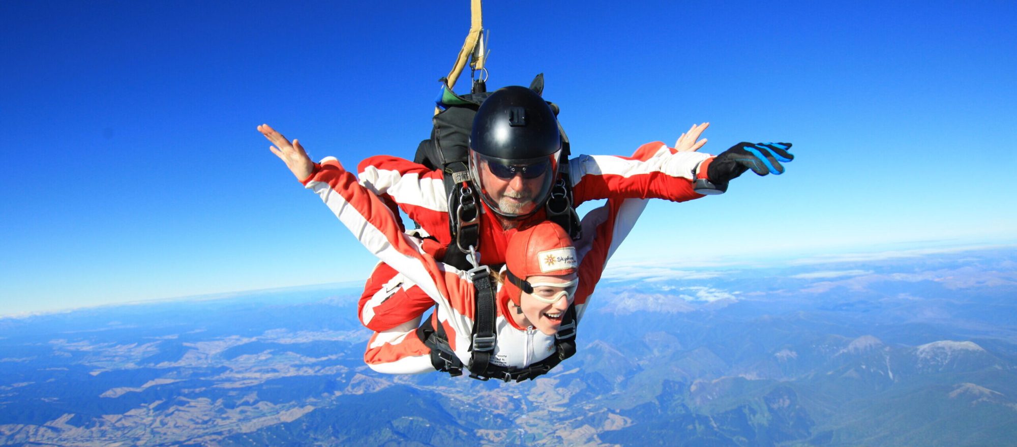 a person flying through the air on top of a mountain