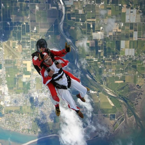 Skydive with the ground on the background.