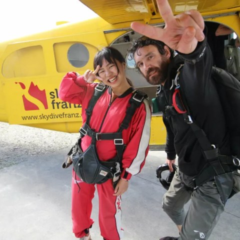 Tandem Skydivers posing before they ride on the helicopter for their jump.