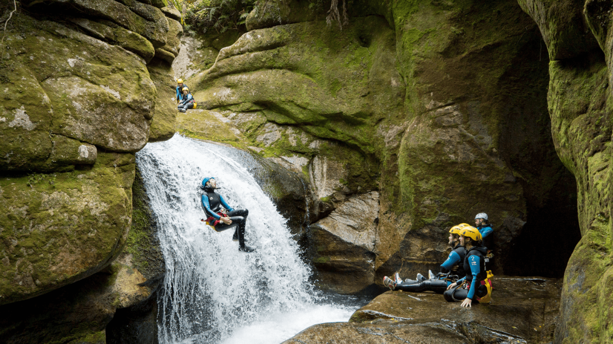 a man riding on the back of a large rock