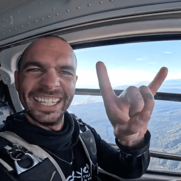 Skydiver with scenery out of large window in helciopter
