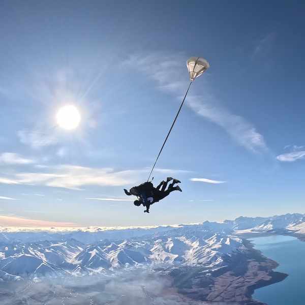 a person flying through the air on a snow covered mountain
