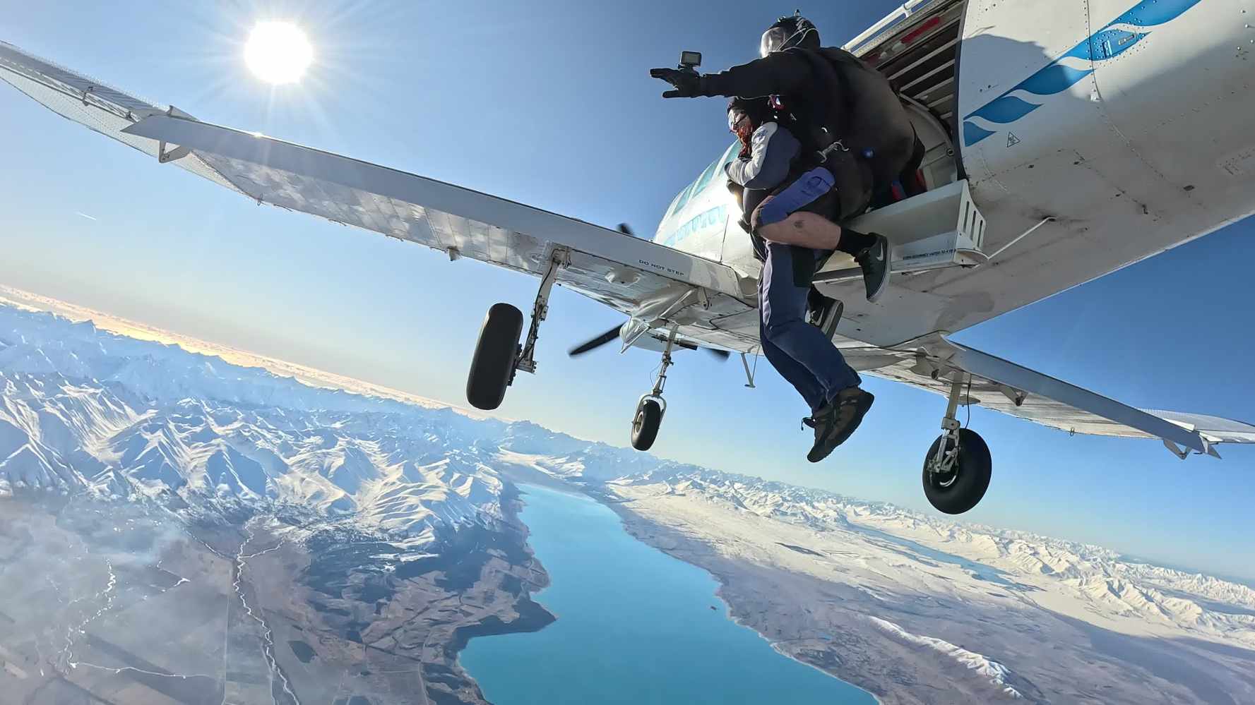 a man flying through the air on a snow covered mountain