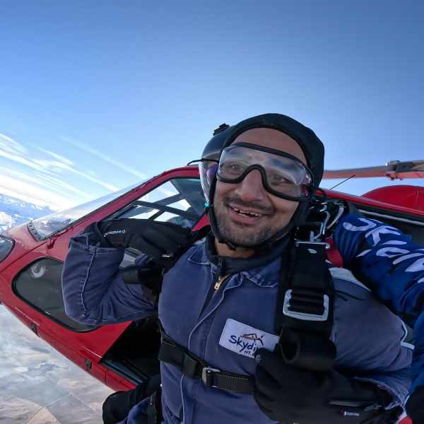 a man sitting on top of a snow covered mountain