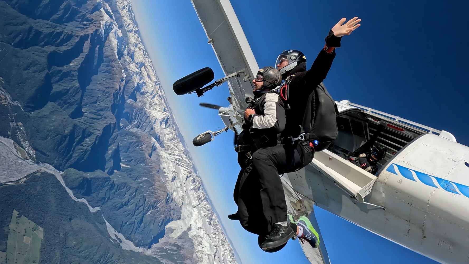 Skydiver exits out of the plane over franz josef