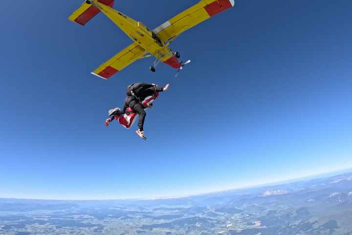 exit shot of skydivers in free fall in teh sky