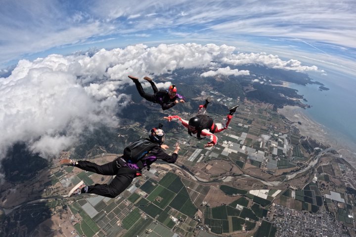 a man flying through the air on a snow covered mountain