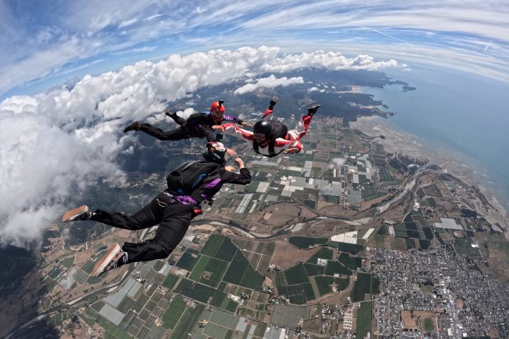 a group of people riding skis on a snowy mountain