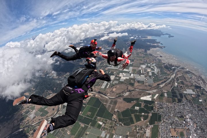 a group of people riding skis on a snowy mountain