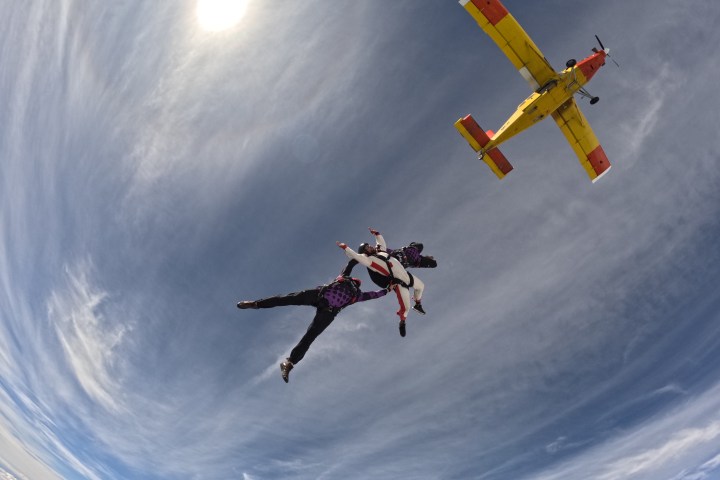 a person flying through the air while riding a skateboard on a ramp